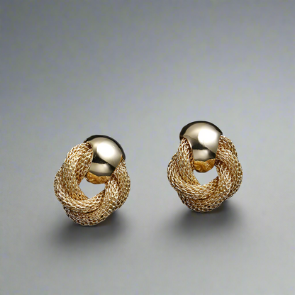 A pair of gold-plated knot earrings elegantly displayed on a neutral studio background, showcasing their intricate braided design and lustrous finish.