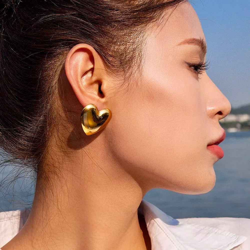 Stylish gold stud earrings with a heartbeat design, a must-have for any jewelry lover.