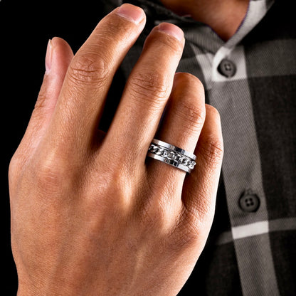 Infinity statement ring worn on a man's hand, showcasing its bold and stylish design.