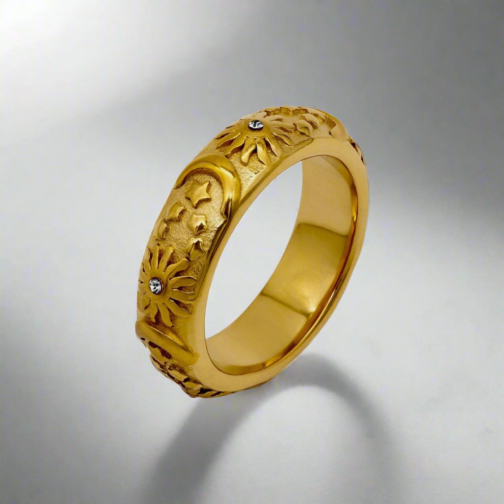 Close-up of the Lunar Elegance Ring, a gold band with intricate moon-inspired cutout patterns.