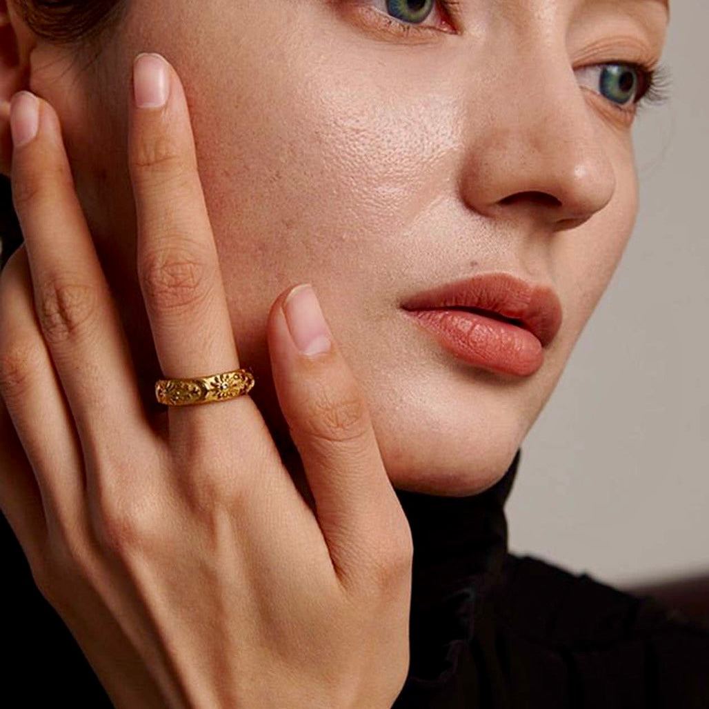 A side profile view of a model wearing the Lunar Elegance Ring, emphasizing its luxurious gold craftsmanship.