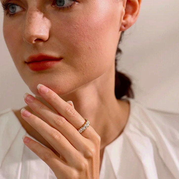 Model wearing the Stellar Eternity Ring in gold, highlighting its geometric crystal design