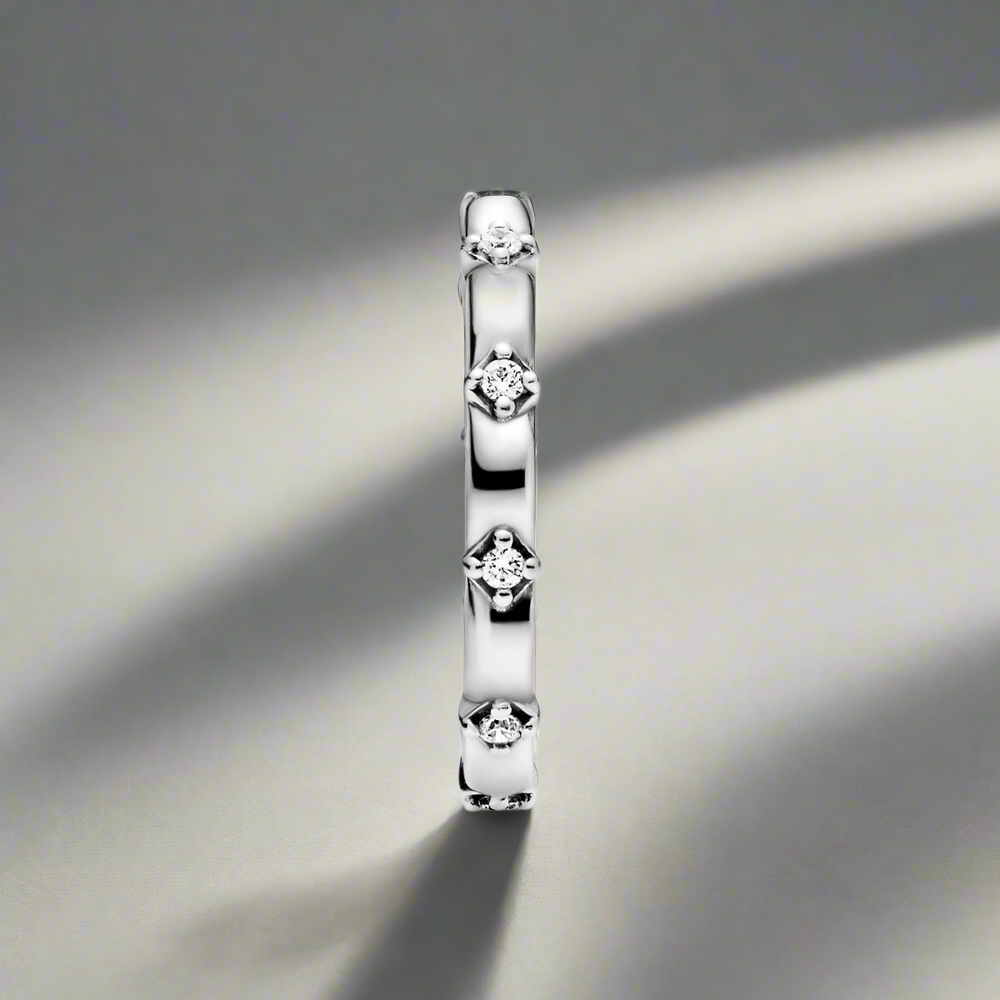 A minimalistic shot of the Opulent Sparkle Ring, highlighting its smooth silver finish and embedded zircon stones.