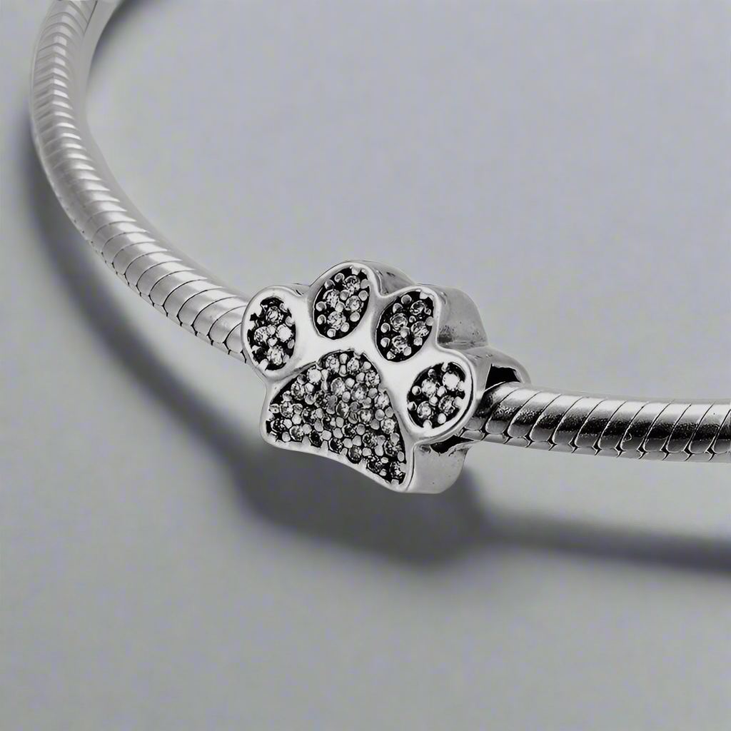 Close-up view of the Paw Print Crystal Bracelet, highlighting the intricate silver details and the crystal paw charm.