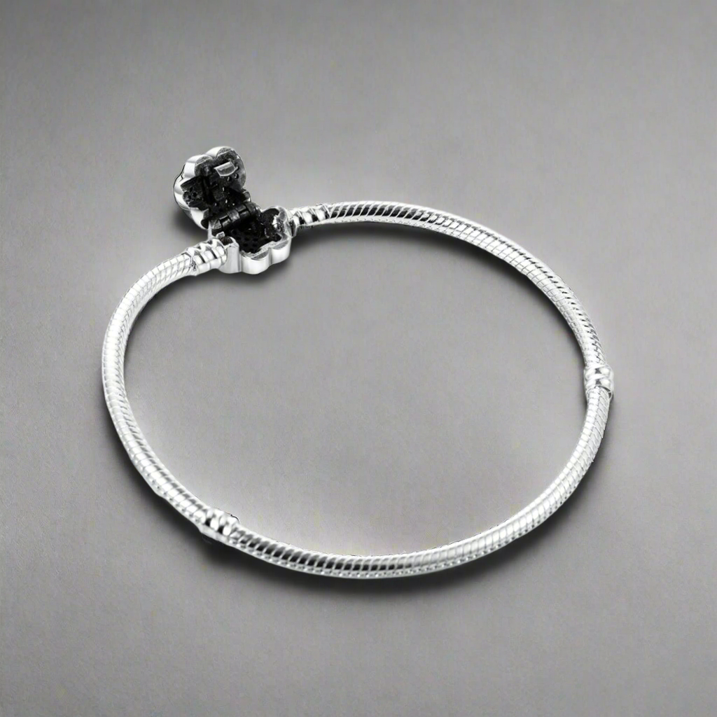 Display view of the Paw Print Crystal Bracelet laid flat, emphasizing its silver chain and decorative paw-shaped charm.