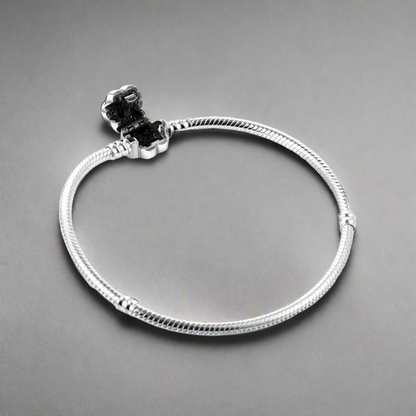 Display view of the Paw Print Crystal Bracelet laid flat, emphasizing its silver chain and decorative paw-shaped charm.