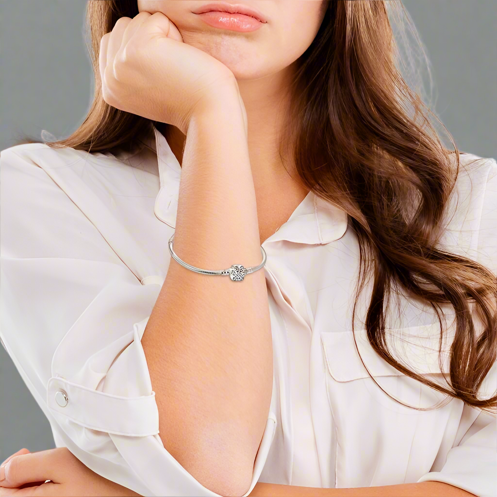 Woman wearing the Paw Print Crystal Bracelet, showcasing its elegant fit and sparkling crystal charm on her wrist.