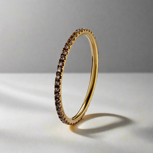 Radiant Eternity Gold Ring with cubic zirconia stones, angled view showcasing its elegant design.