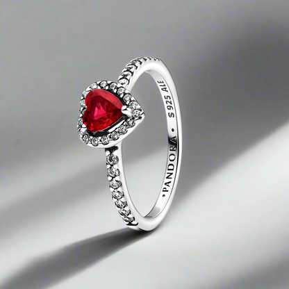 Front view of the Radiant Ruby Heart Ring, showcasing a sterling silver band and a vibrant red heart-shaped crystal.