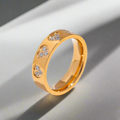 Seraphine Halo Ring in gold with diamond accents on a sleek gray background, showcasing its elegant design.