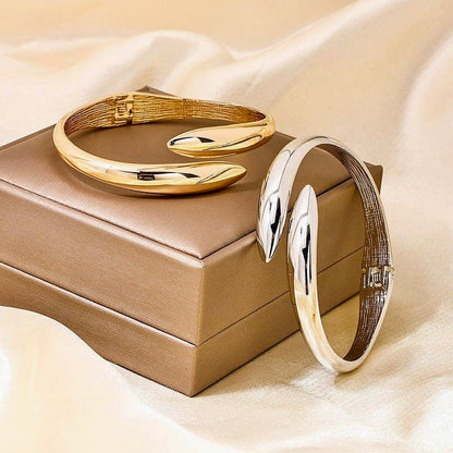 Serpentine Elegance Bracelet in gold finish displayed elegantly on a jewelry box, emphasizing its luxurious style.