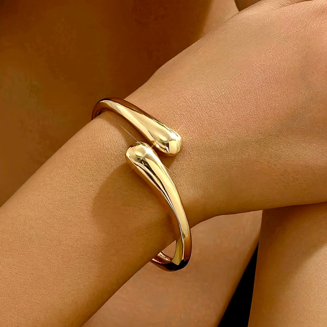 Model wearing the Serpentine Elegance Bracelet in gold finish, showcasing its elegant wrap-around snake motif on the wrist.