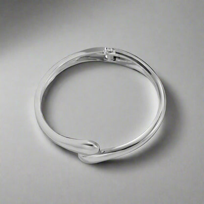 Serpentine Elegance Bracelet in silver finish, featuring a sleek and modern snake design on a neutral background.