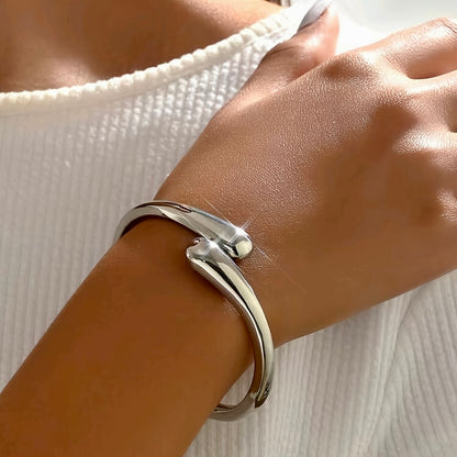 Model wearing the Serpentine Elegance Bracelet in silver finish, showcasing its minimalist snake-inspired design on the wrist.