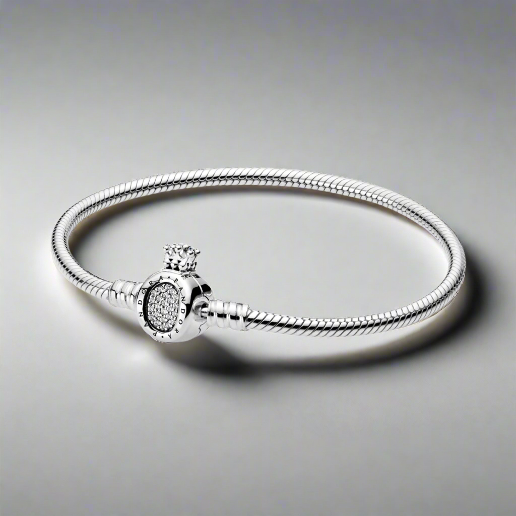 The Silver Majesty Charm Bracelet displayed in a neutral-toned setting, perfect for showcasing its timeless elegance.