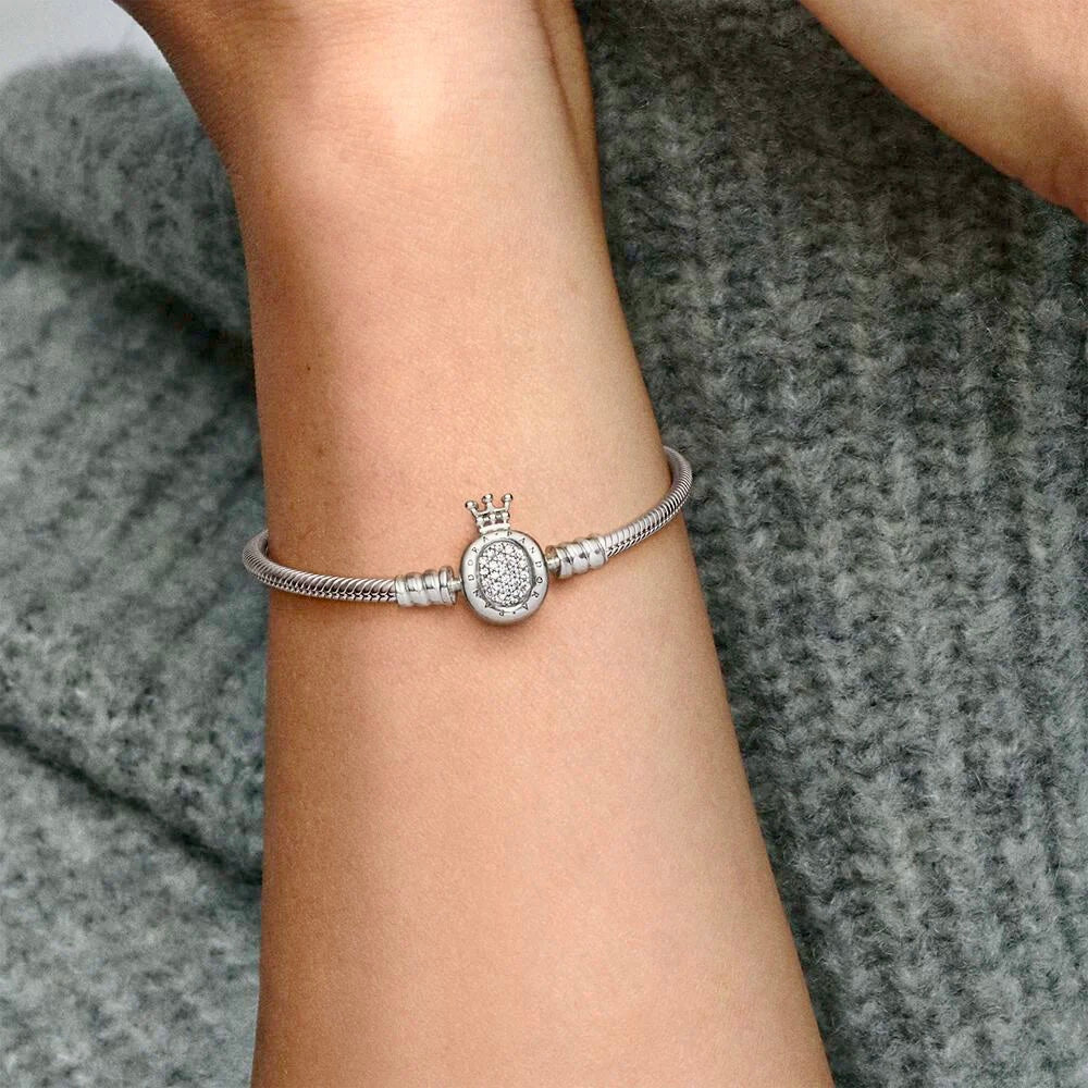 A side view of the Silver Majesty Charm Bracelet worn on the wrist, emphasizing its graceful curve and silver-tone finish.