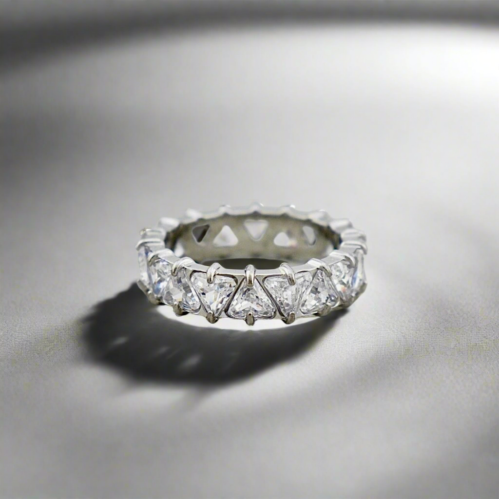 Stellar Eternity Ring in silver with geometric crystal patterns, displayed under soft lighting.