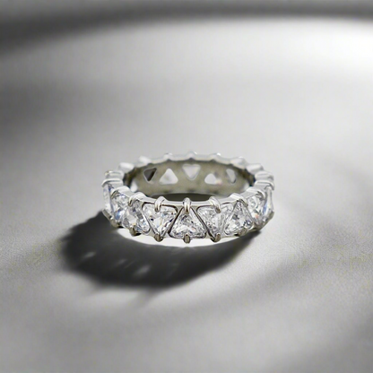 Stellar Eternity Ring in silver with geometric crystal patterns, displayed under soft lighting.