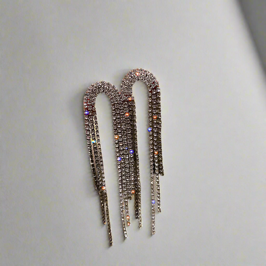 Close-up view of Starlight Fringe Drop Earrings in shimmering silver with cascading rhinestones.