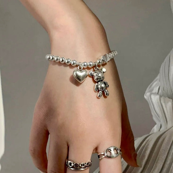 Worn view of the Love & Peace Teddy Charm Bracelet, demonstrating its elegance and trendy cuff design for women.